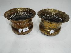 A pair of brass plant pots,