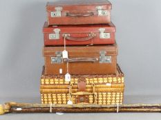 Three vintage cases, three walking sticks and a picnic set.