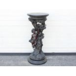 A decorative jardiniere stand of naturalistic form depicting a putto sat in a tree feeding a