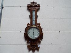A highly carved banjo barometer / thermometer.