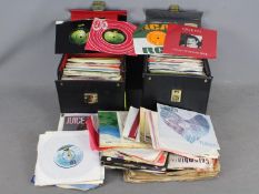 A collection of 7" vinyl records to include Queen, The Beach Boys, The Beatles, The Kinks,