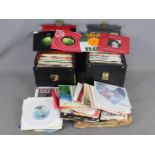 A collection of 7" vinyl records to include Queen, The Beach Boys, The Beatles, The Kinks,