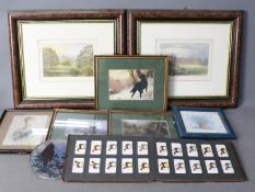 A collection of framed prints and a ciga