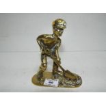 A brass figure in the form of a coal min