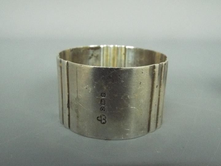 Four hallmarked silver napkin rings, - Image 4 of 4