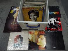 A large quantity of 12" vinyl records to include Neneh Cherry, Commodores, Paula Abdul, Rod Stewart,