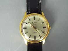 A B Jobin 17 jewel wristwatch on black leather strap.