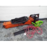 A Flymo Garden Vac and an electric hedge trimmer.