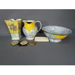 A Poole Pottery wash bowl and jug with floral decoration, an Arthur Wood vase,