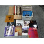 Two boxes of 12" vinyl records to include Howard Jones, Roxy Music, Go West, Elton John and other.