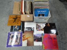 Two boxes of 12" vinyl records to include Howard Jones, Roxy Music, Go West, Elton John and other.