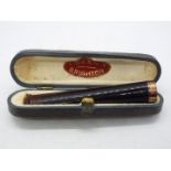 A 9ct gold mounted cheroot holder contained if fitted case.