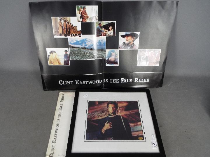 Clint Eastwood - A signed photograph, mounted and framed under glass,