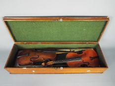 Two violins with bows, no makers name found, contained in wooden case.