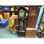 A modern Tempus Fugit longcase clock with pendulum and two weights,