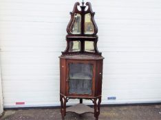 A glazed mahogany corner unit with mirror back upper section, approximately 190 cm x 70 cm x 45 cm.