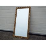 A wall mirror with scrollwork frame, approximately 96 cm x 48 cm.