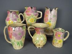 A quantity of Art Deco, Arthur Wood, ceramics with floral decoration and silvered rims,