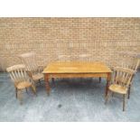 A pine dining table measuring approximately 73 cm x 172 cm x 99 cm with four chairs and two carvers.