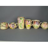 A quantity of Arthur Wood, Art Deco ceramics with floral decoration and silvered highlights,
