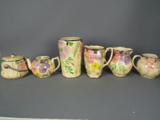 A quantity of Arthur Wood, Art Deco ceramics with floral decoration and silvered highlights,