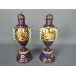 A pair of Vienna style, porcelain urns and covers,