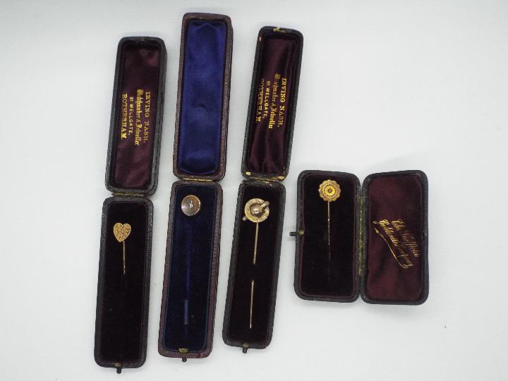 Four yellow metal stick pins, two of which are stone set, each contained in a case. - Image 3 of 3