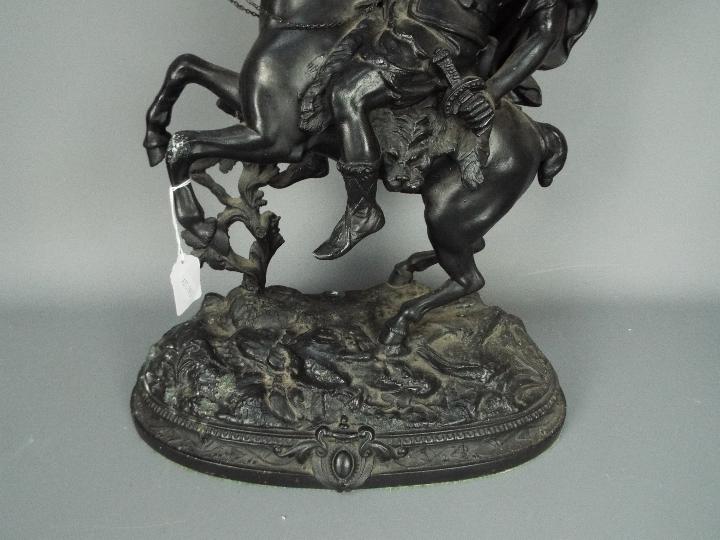 A cast metal sculpture depicting a warrior on horseback, approximately 53 cm (h). - Image 3 of 4