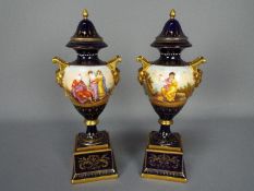 A pair of Vienna style, porcelain urns and covers,