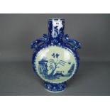 A large blue and white moon flask raised on splayed oval foot,