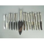 A silver handled cake server and two sets of six silver handled butter knives,