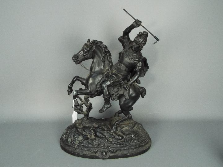 A cast metal sculpture depicting a warrior on horseback, approximately 53 cm (h).