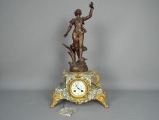 An early 20th century French figural mantel clock, the case of pale green and white marble,