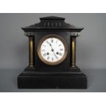 A late 19th century French black slate mantel clock of architectural form,