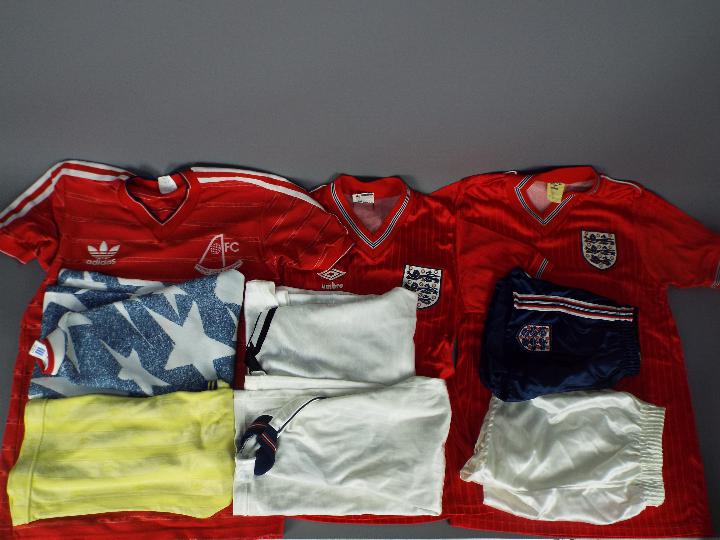 A collection of vintage, replica football shirts, 1980's and later, varying sizes.