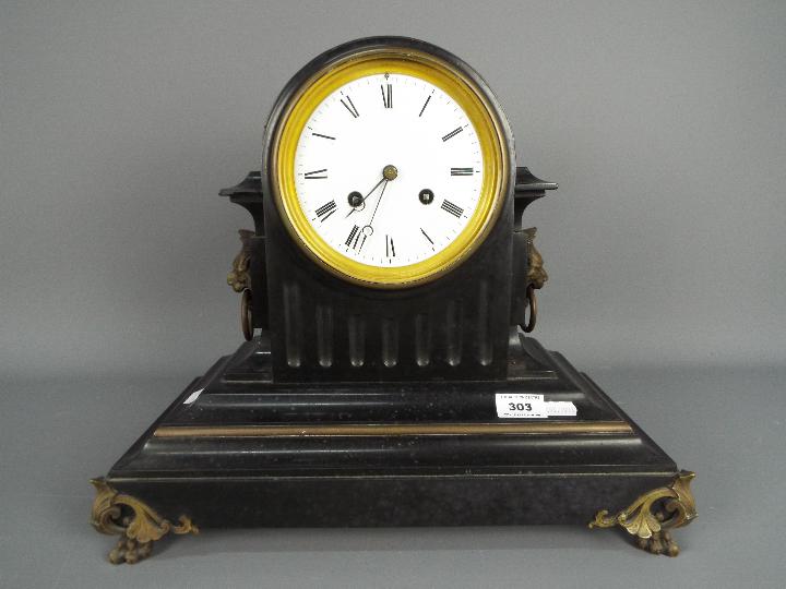 A late 19th century French black slate mantel clock of fluted drum head form,
