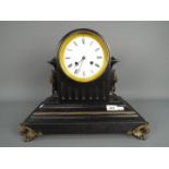 A late 19th century French black slate mantel clock of fluted drum head form,