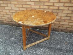 An antique cricket table measuring approximately 62 cm x 72 cm.
