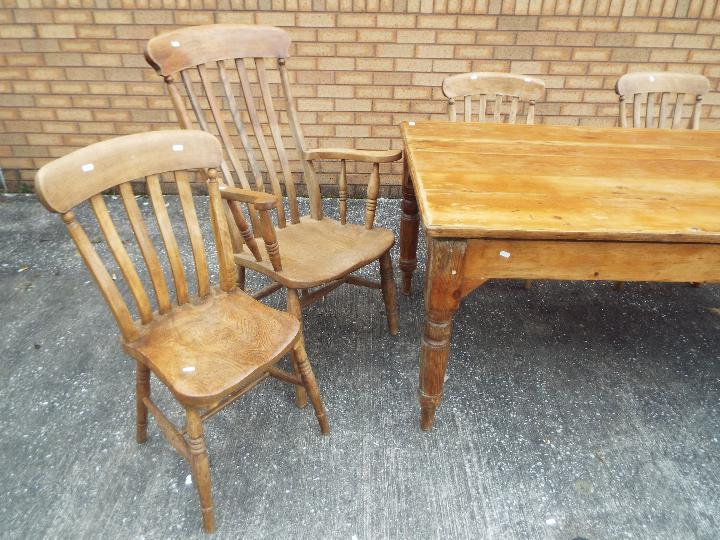 A pine dining table measuring approximately 73 cm x 172 cm x 99 cm with four chairs and two carvers. - Image 3 of 4