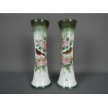 A pair of glass vases with hand painted decoration of birds and flowers, approximately 31 cm (h).