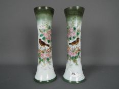 A pair of glass vases with hand painted decoration of birds and flowers, approximately 31 cm (h).