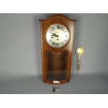 A late 20th century Rapport, Westminster chime, wall clock with key and pendulum,