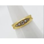 A late Victorian 18ct gold ring set with diamonds and seed pearls, size N, approximately 3.