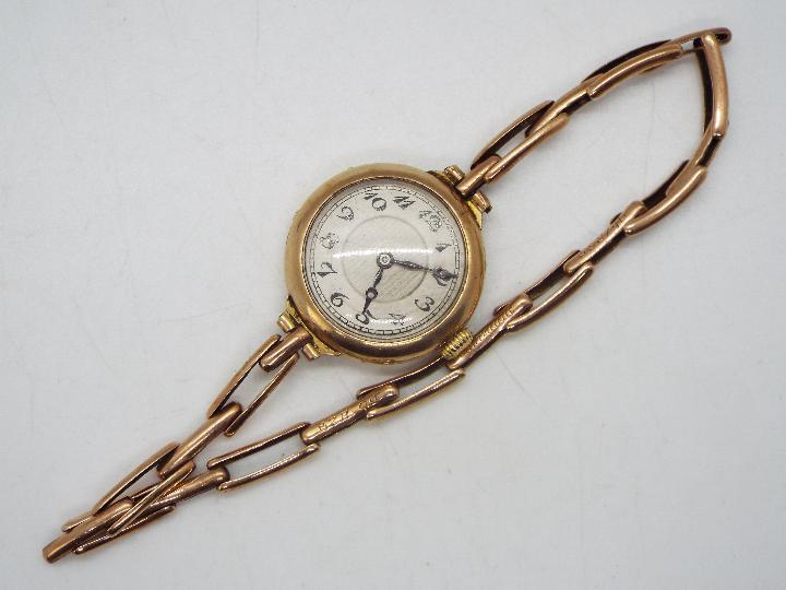A lady's 9ct gold cased wristwatch on expanding bracelet marked Britannic 9ct (bracelet A/F),