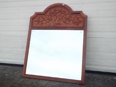 A large Chinese style mirror decorated with songbirds and prunus, approximately 115 cm x 90 cm.