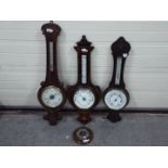 Three banjo barometers, largest approximately 95 cm and one other.