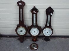 Three banjo barometers, largest approximately 95 cm and one other.