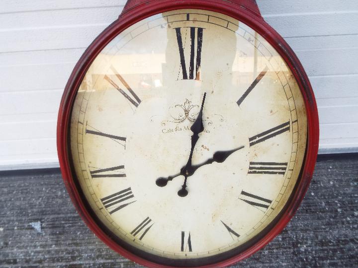 A large, antique style wall clock in the form of a pocket watch, approximately 97 cm x 46 cm. - Image 2 of 2