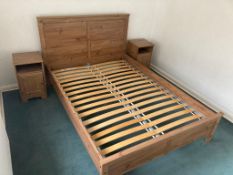 A double bed with a pair of bedside cabinets.