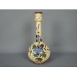 An early 20th century glass vase with hand painted floral decoration, signed to the base,